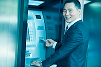 Person smiling while using innovative ATM from NCR dealer in NJ