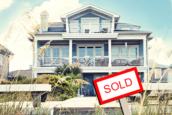 Homes for sale in Ortley Beach like this blue house with white trim sell fast; small sold icon in lower right corner