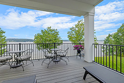 Farmhouse style covered deck on a waterfront home designed by deck builder in Long Beach Island