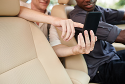People using mobile phone to perform a search in the car